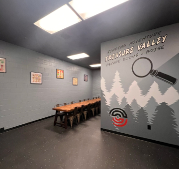 The long table beside the painted mural wall